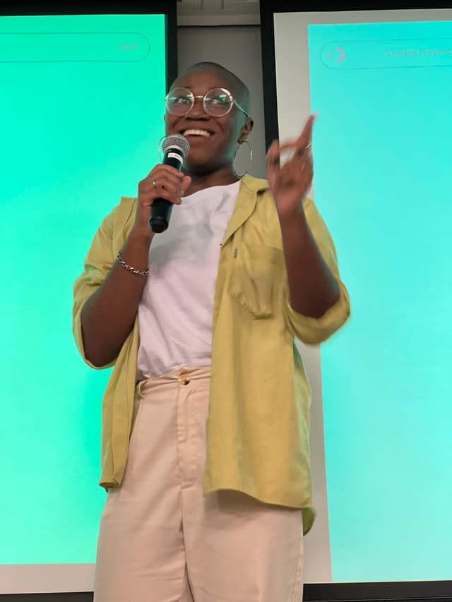 Dandara giving a talk on stage